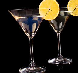 Martini glasses on black background