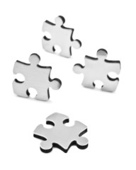 Stainless steel puzzles pieces on white background