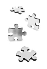 Stainless steel puzzles pieces on white background
