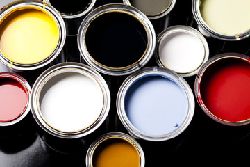 Cans and paint on the colourful background