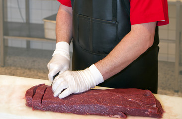 Butcher cutting meat