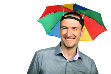 Portrait of  happy businessman with rainbow hat umbrella on head