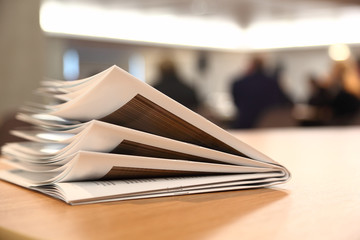 several brochures on light table in bright room