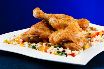 Roasted chicken legs, rice and vegetables