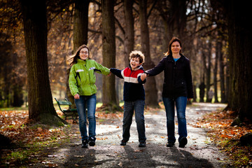 Obraz premium Active family - mother and kids walking outdoor