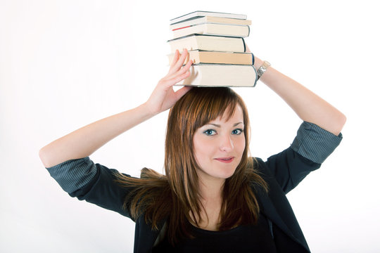 Junge Frau trägt Bücher au dem Kopf 420