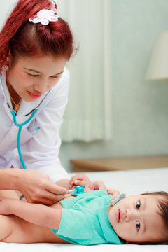 Female doctor checking baby petient