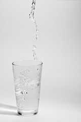 Water pourring into glass.