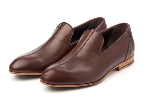 Pair of brown male shoes over white background