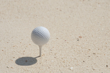 white Golf ball on the white sand