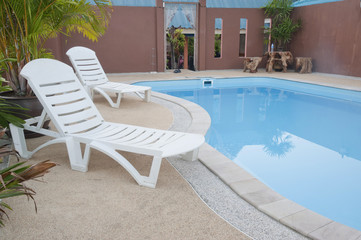 beautiful swimming pool surrounded by chairs