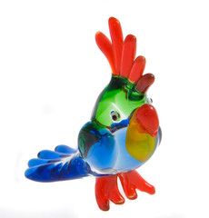 Colorfull glass statuette of a parrot on white background