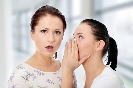 Two happy young girlfriends