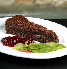 a slice of chocolate cake on white plate