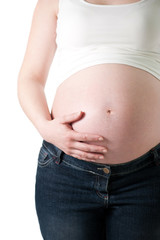 pregnant woman holding her belly with one hand on white