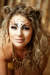 Fototapeta premium Girl with an unusual make-up as a leopard