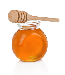 glass pot full of honey on white