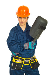 Serious worker woman with welding mask