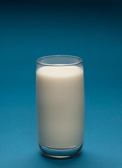 Glass of milk on a blue