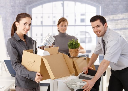 Young office workers moving office