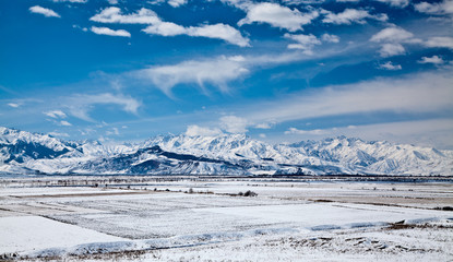 Panoramic landscape of snowy mountains in the spring