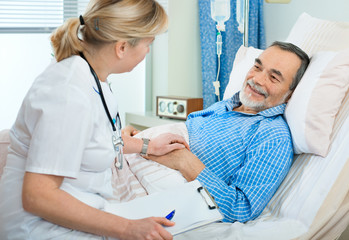 doctor or nurse talking to patient in hospital