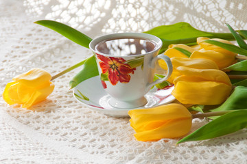 morning cup of tea with yellow tulips