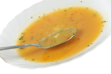 Spoon in a soup plate on white background
