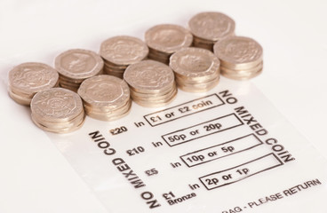 Money bag with sterling twenty pence coins