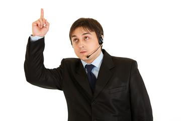 Interested modern businessman with headset pointing finger up
