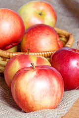 Apples on a sacking on a wooden table