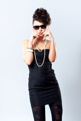 Fototapeta premium Fashion woman in sexy black dress