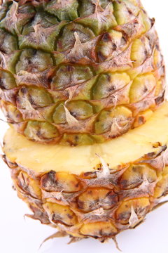 Pineapple - cut in half, in close up on white background
