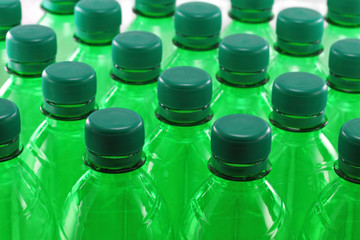 Green plastic bottles in a row