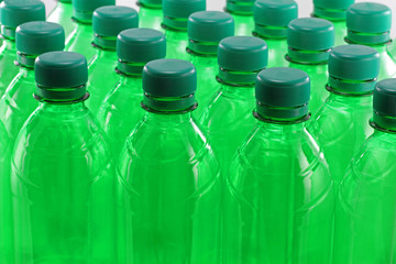 Green plastic bottles in a row