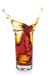 Ice falling in glass with black tea