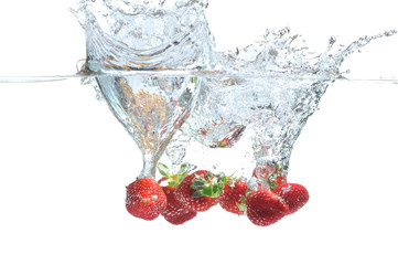 Strawberry falling in water