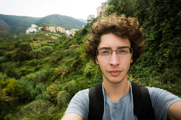 Naklejka na ściany i meble Young traveler and hiker looking at the camera, Italy