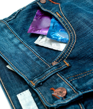 condom in jeans over white