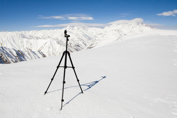 Tripod surrounded with mountains