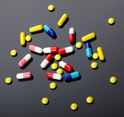 Colorful pills over dark background