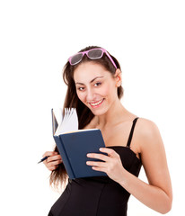 Pretty young girl with book, pen and glasses isolated on white