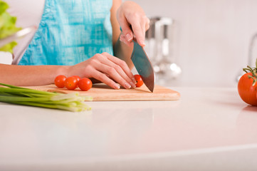 Young woman cutting vegetables in a kitchen