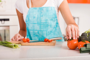 Woman cutting vegetables in a kitchen