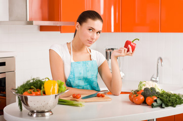 Beautiful young woman cooking in the kitchen
