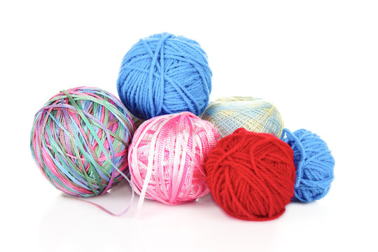 Knitting yarn and  knitting needles on white