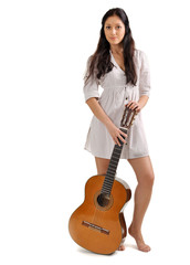 Young beautiful brunette girl in white chemise with acoustic gui
