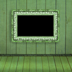 Photo frame hanging on the green blurred wall - old album backgr