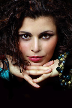 Passionate woman with jewelry on dark background