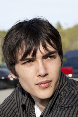 Young teen man outdoor portrait piercing lip